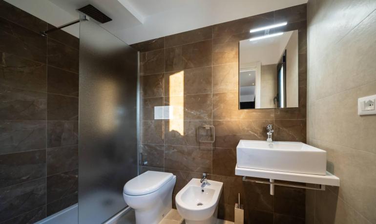 Bagno moderno con doccia, lavabo, WC e bidet.